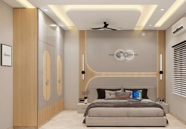 Bedroom wardrobe design with laminated sliding shutters and cove false ceiling in Bikaner