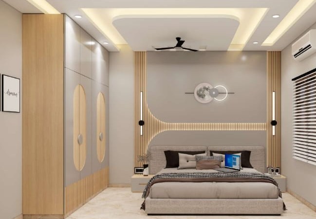 Bedroom wardrobe design with laminated sliding shutters and cove false ceiling in Bikaner